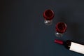 Glasses of red wine and bottle of red wine with white label on dark background Royalty Free Stock Photo