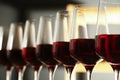 Glasses of red wine in cellar, closeup. Royalty Free Stock Photo