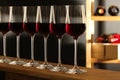 Glasses of red wine in cellar. Royalty Free Stock Photo