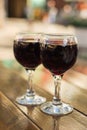 Glasses with red wine on a table at an outdoor cafe with a blurred background and bokeh