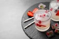 Glasses of refreshing drink with ice cubes and berries on grey table, closeup. Space for text Royalty Free Stock Photo