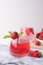 Glasses with refreshing strawberry lemonade and strawberries on white background, summer fruit drinks concept Royalty Free Stock Photo