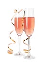 Glasses of rose champagne with gold streamer isolated Royalty Free Stock Photo