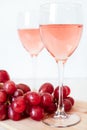 Glasses of rose wine and red grapes on white background. two glasses of champagne Royalty Free Stock Photo