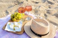 Glasses with rose wine and snacks for beach picnic on sand outdoors Royalty Free Stock Photo