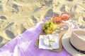 Glasses with rose wine and snacks on beach sand outdoors. Space for text Royalty Free Stock Photo