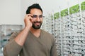 Glasses Shop. Man Trying On Eyeglasses In Optics Store