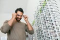 Glasses Shop. Man Trying On Eyeglasses In Optics Store