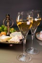 Glasses of sparkling white wine champagne or cava with bubbles and french soft cheese on background