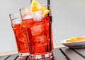 Glasses of spritz aperitif aperol cocktail with orange slices and ice cubes near plate of slices oranges Royalty Free Stock Photo