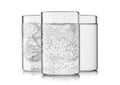 Glasses with still and sparkling water with ice cubes and bubbles on white background Royalty Free Stock Photo