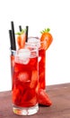 Glasses of strawberry cocktail with ice on old wood table Royalty Free Stock Photo