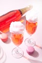 Glasses with sweet cotton candy pink cocktail and bottle on background Royalty Free Stock Photo