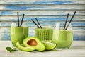 Glasses of tasty avocado smoothie and fresh fruits on wooden table Royalty Free Stock Photo