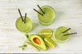 Glasses of tasty avocado smoothie and fresh fruits on wooden table Royalty Free Stock Photo