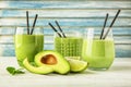 Glasses of tasty avocado smoothie and fresh fruits on wooden table Royalty Free Stock Photo