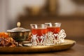 Glasses with tasty Turkish tea and oriental sweets on wooden table indoors, space for text