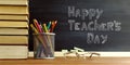 Glasses teacher books and a stand with pencils on the table, on the background of a blackboard with chalk. The concept of the Royalty Free Stock Photo