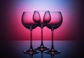 Glasses. Three empty glasses for wine on a colored background. Color coloring. In a low key Royalty Free Stock Photo
