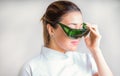 Glasses to protect your eyes from laser radiation in the hands of cosmetologist