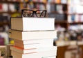 Glasses on top of different books lying on table in school libra Royalty Free Stock Photo