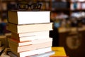 Glasses on top of different books lying on table in school library Royalty Free Stock Photo