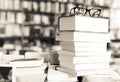Glasses on top of stack of books lying on table in bookstore Royalty Free Stock Photo