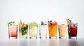 Glasses with various alcoholic cocktails in a row with fruits, white background. AI generated