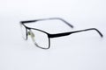Glasses for the visually impaired, poorly sighted.glasses with aspherical astigmatic lenses  in black frame on a white background. Royalty Free Stock Photo