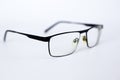 Glasses for the visually impaired, poorly sighted.glasses with aspherical astigmatic lenses in black frame on a white background.