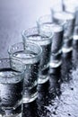 Glasses of vodka on a damp glass table Royalty Free Stock Photo