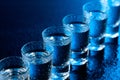 Glasses of vodka on a damp glass table Royalty Free Stock Photo