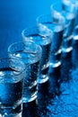 Glasses of vodka on a damp glass table Royalty Free Stock Photo