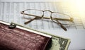 Glasses, wallet and dollars bill on financial report blurred. business concept Royalty Free Stock Photo