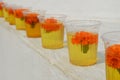 Glasses with water and carnation flowers at The Great stupa Bodnath in Kathmandu, Nepal. Royalty Free Stock Photo