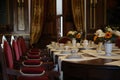 Glasses of water on the elegant table. table setting in the castle. velvet chairs and coffee cups