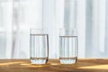 Glasses of water standing on wooden table inside Royalty Free Stock Photo