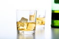 Glasses of whiskey and ice on white background Royalty Free Stock Photo