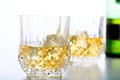 Glasses of whiskey and ice on white background Royalty Free Stock Photo