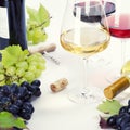 Glasses of white, red and rose wine and grapes Royalty Free Stock Photo