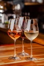 Glasses of white, rose and red wine are on the table, a bottle and corks are nearby. Glasses are on the table in the bar Royalty Free Stock Photo