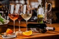 Glasses of white, rose and red wine are on the table, a bottle and corks are nearby. Glasses are on the table in the bar Royalty Free Stock Photo