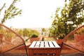 Glasses of white wine on rustic wooden table and flower pots on terrace outside Royalty Free Stock Photo