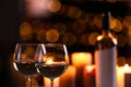 Glasses of wine and blurred view of burning candles