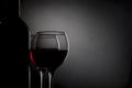 Glasses with wine, bottle isolated on black gradient Royalty Free Stock Photo