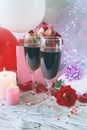 Glasses of wine, gifts, a bouquet of fresh roses, burning candles and balloons, the concept of a holiday, congratulations, happy b Royalty Free Stock Photo