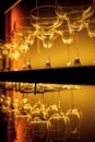 Glasses of wine. Glasses hanging above the bar in the restaurant. Empty glasses for wine Royalty Free Stock Photo