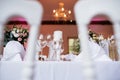 glasses and wine goblets are set at the end of the dinner table Royalty Free Stock Photo