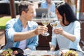 Glasses with wine in hands of a nice happy couple