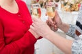 Glasses of wine in the hands of women. Man serves glasses of wine to a girl in red dress at festive decoration. Holiday drink. Royalty Free Stock Photo